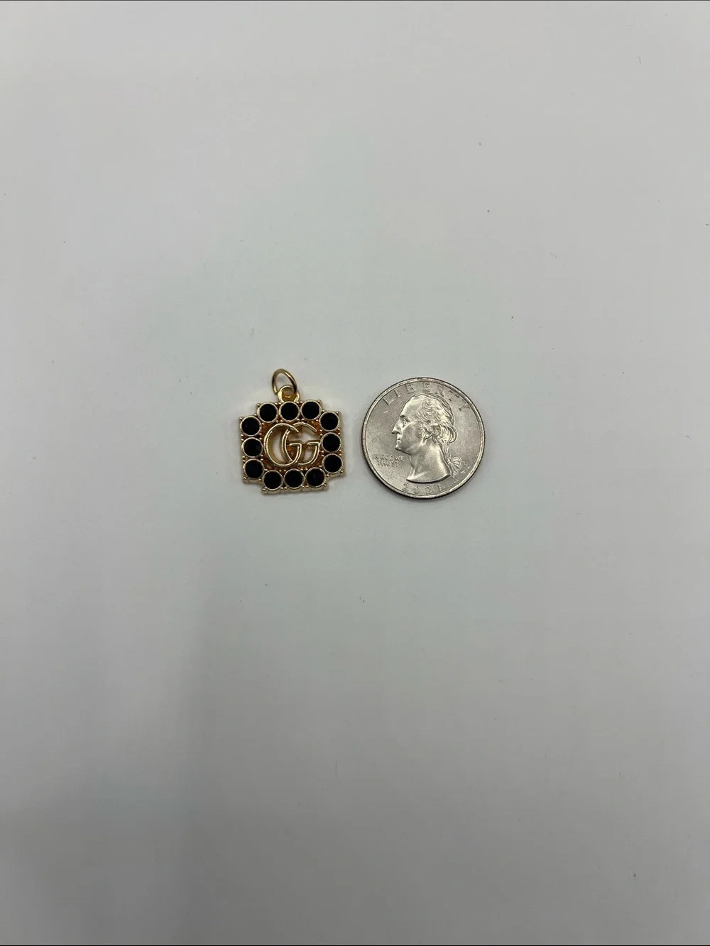 1430. Gold and Black Crystal Logo Charm Pendant